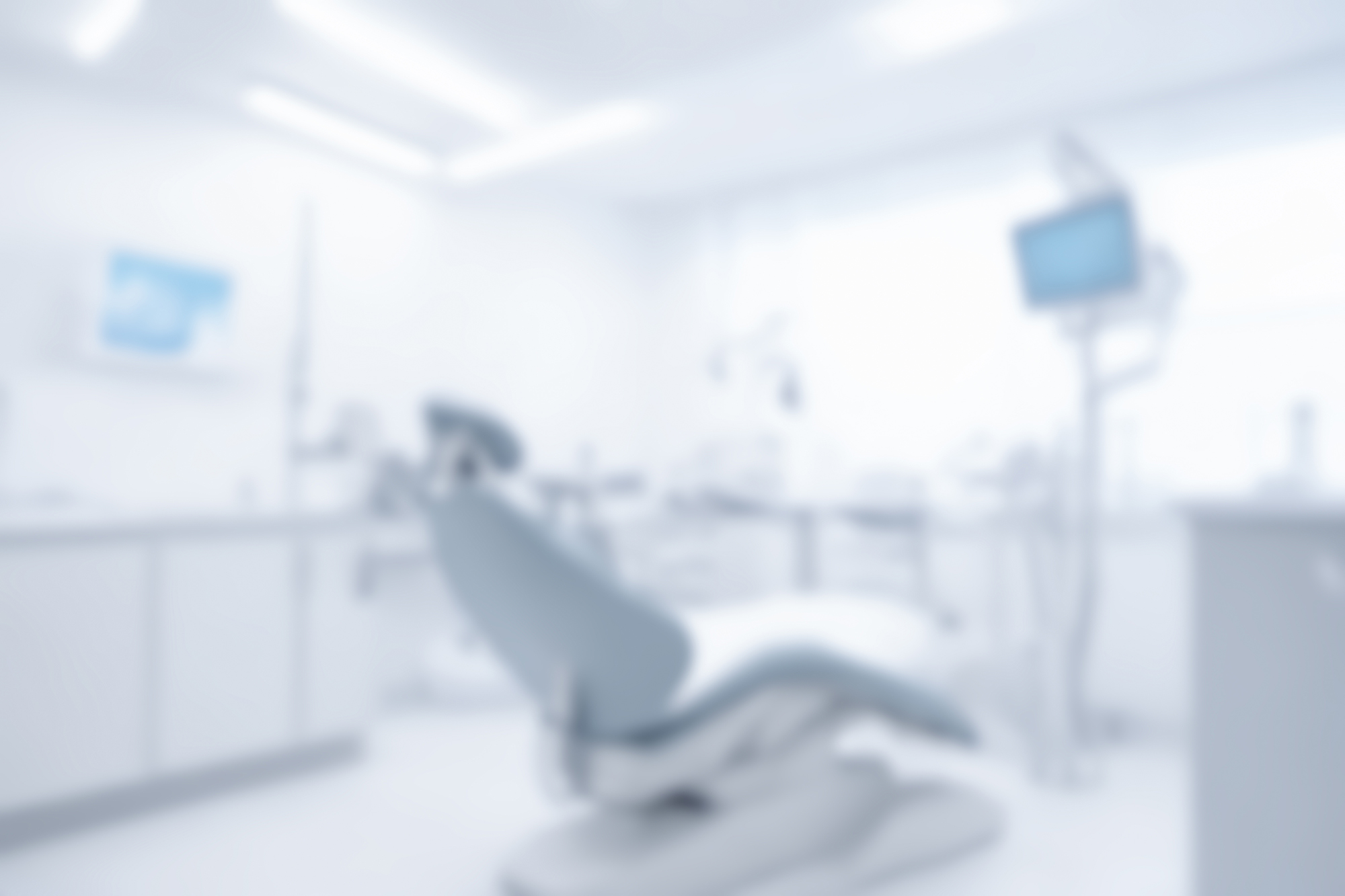 Dental,Clinic,Interior,Blurred,Background,With,Chair,In,Center,,Medical